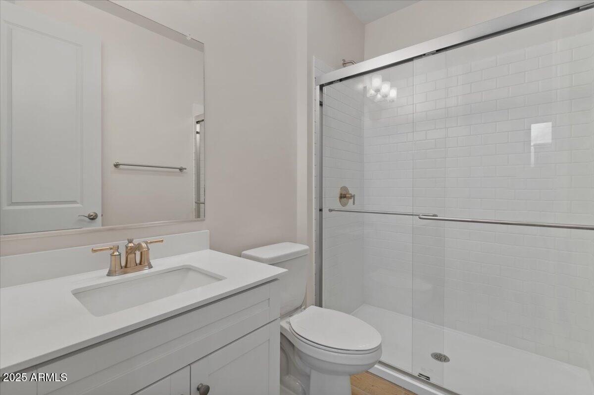 2431 West Los Arboles Place Chandler, AZ 85224 - Photo 28 of 60 a bathroom with a sink toilet and shower