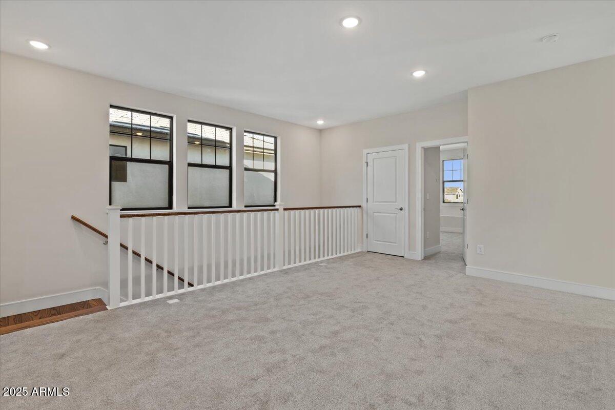 2431 West Los Arboles Place Chandler, AZ 85224 - Photo 30 of 60 wooden floor in an empty room with windows