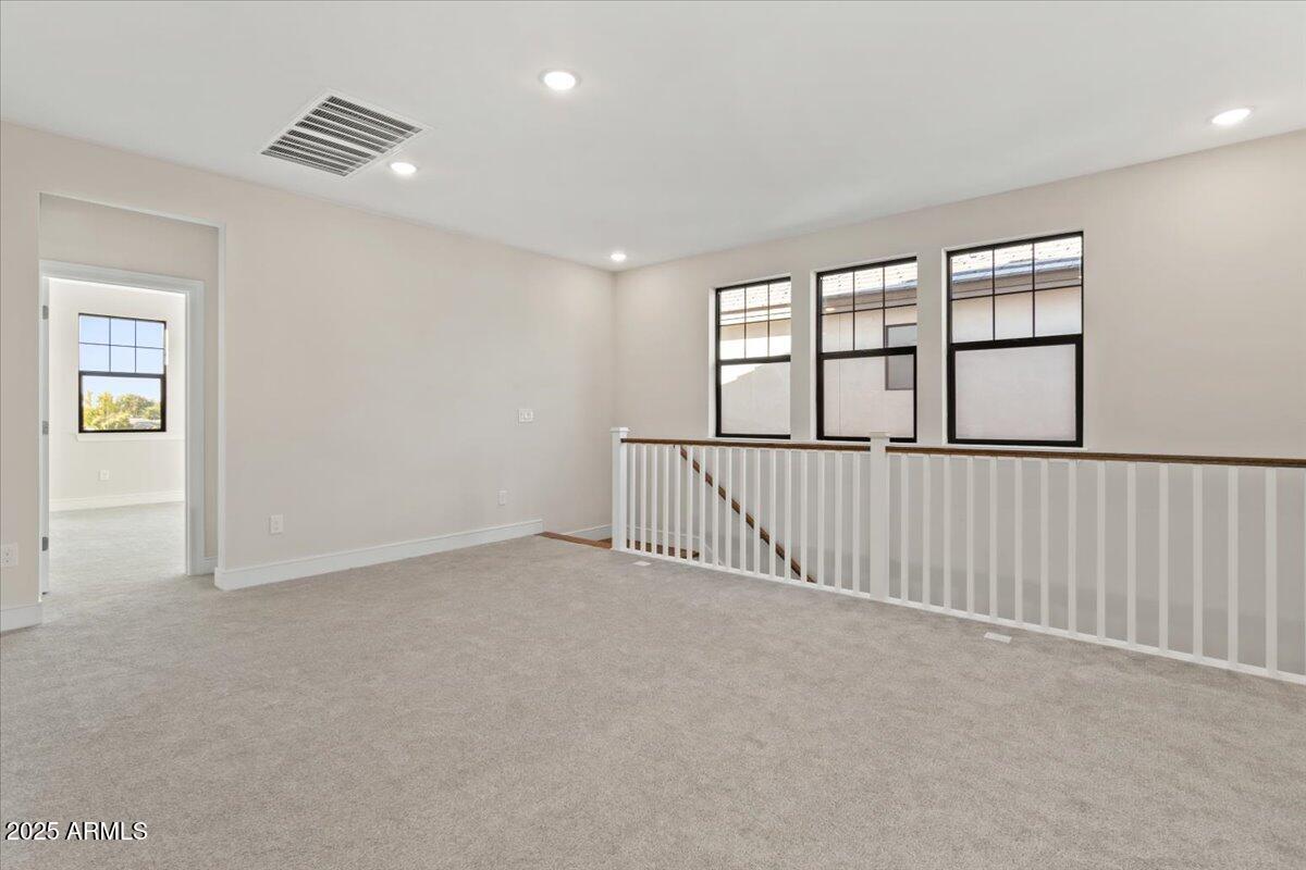 2431 West Los Arboles Place Chandler, AZ 85224 - Photo 31 of 60 wooden floor in an empty room with a window