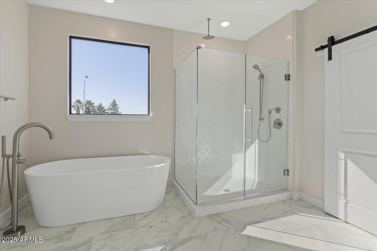 2431 West Los Arboles Place Chandler, AZ 85224 - Photo 37 of 60 a white tub sitting next to a bathroom