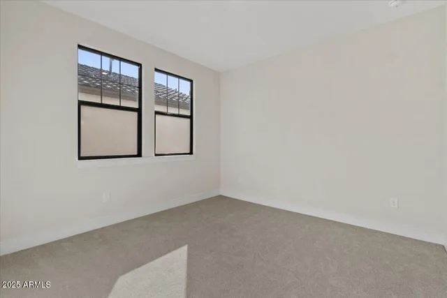 an empty room with windows and closet
