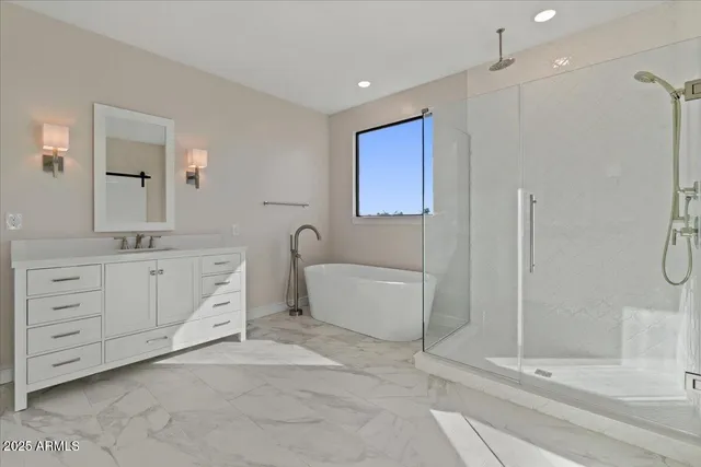 a white bath tub sitting next to a toilet