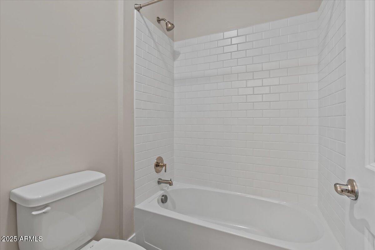 2431 West Los Arboles Place Chandler, AZ 85224 - Photo 44 of 60 a white bath tub sitting next to a toilet