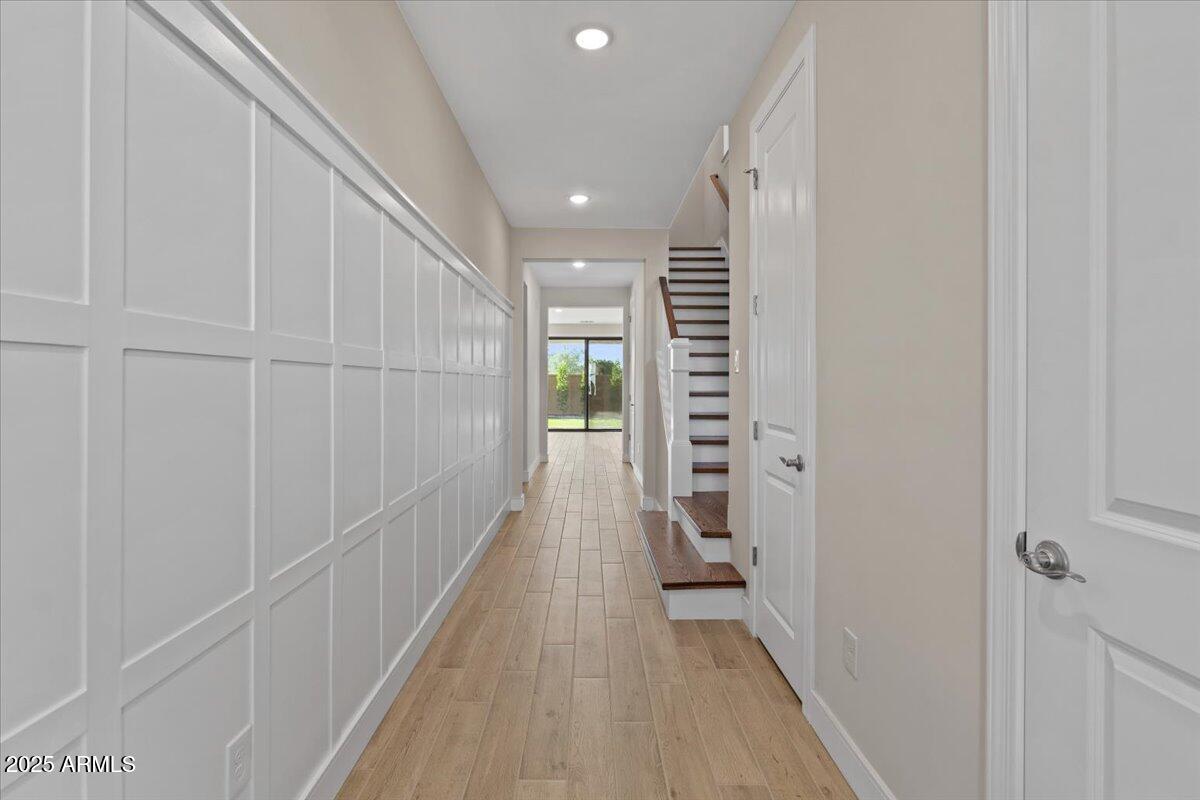 2431 West Los Arboles Place Chandler, AZ 85224 - Photo 7 of 60 a view of a hallway with wooden floor and staircase