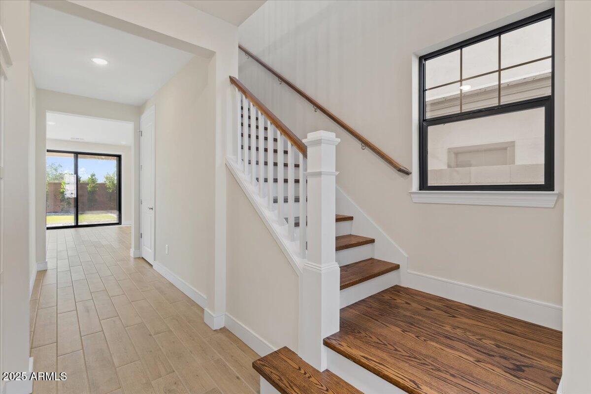 2431 West Los Arboles Place Chandler, AZ 85224 - Photo 8 of 60 a view of staircase with wooden floor and a rug