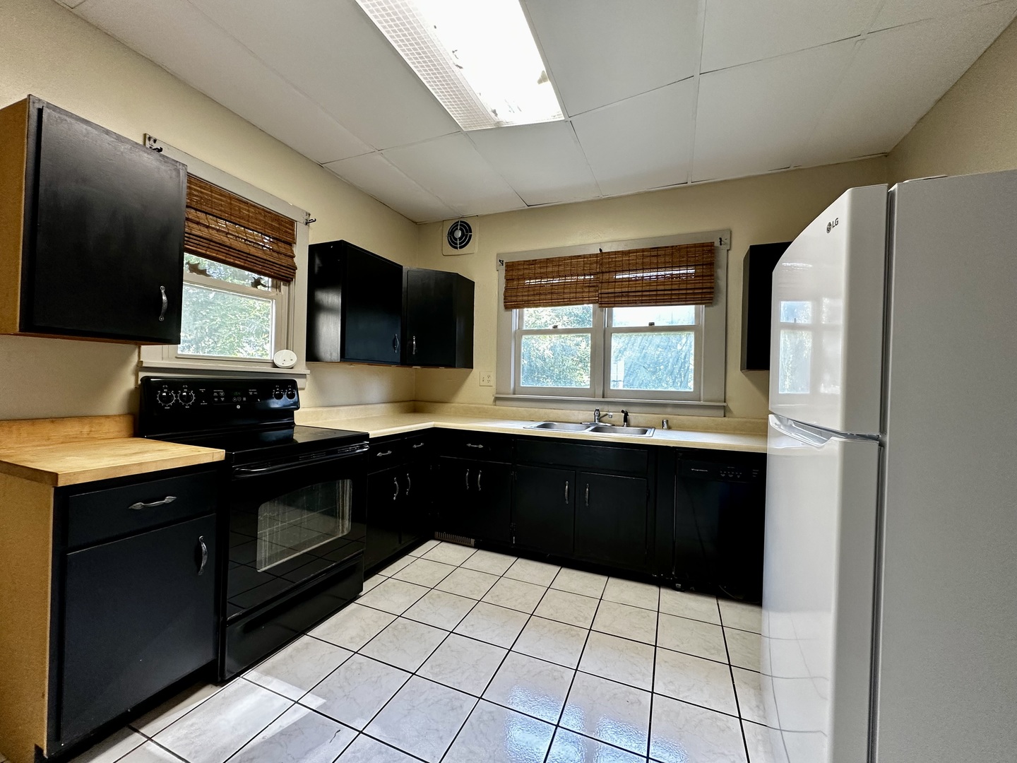 212 North Linden Street Clinton, IL 61727 - Photo 5 of 16 a kitchen with a sink a stove top oven and cabinets