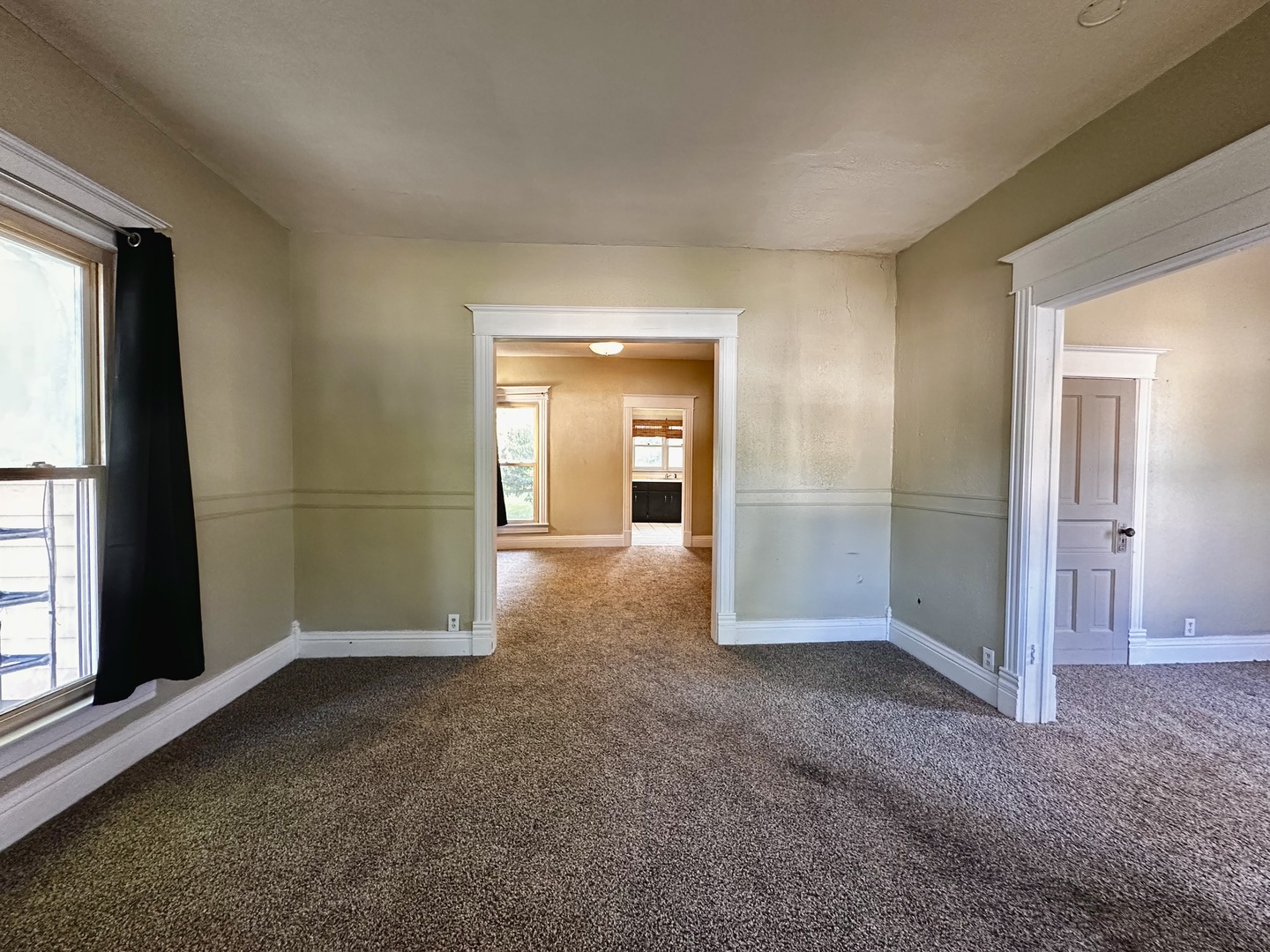 212 North Linden Street Clinton, IL 61727 - Photo 6 of 16 an empty room with windows and entrance