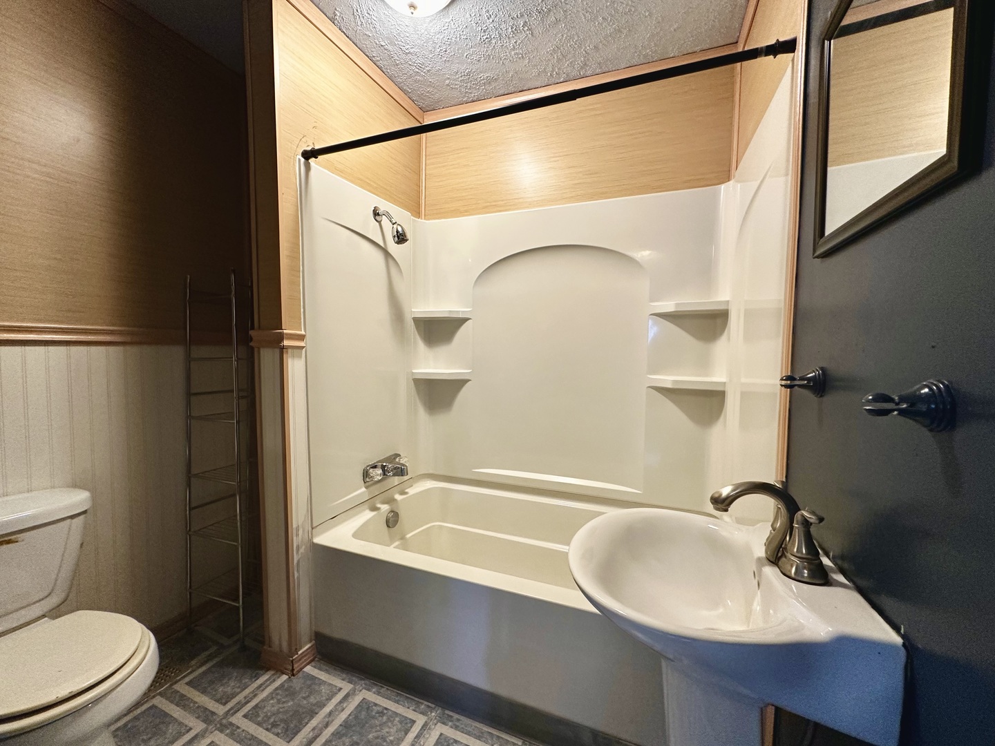 212 North Linden Street Clinton, IL 61727 - Photo 8 of 16 a bathroom with a sink a toilet and shower