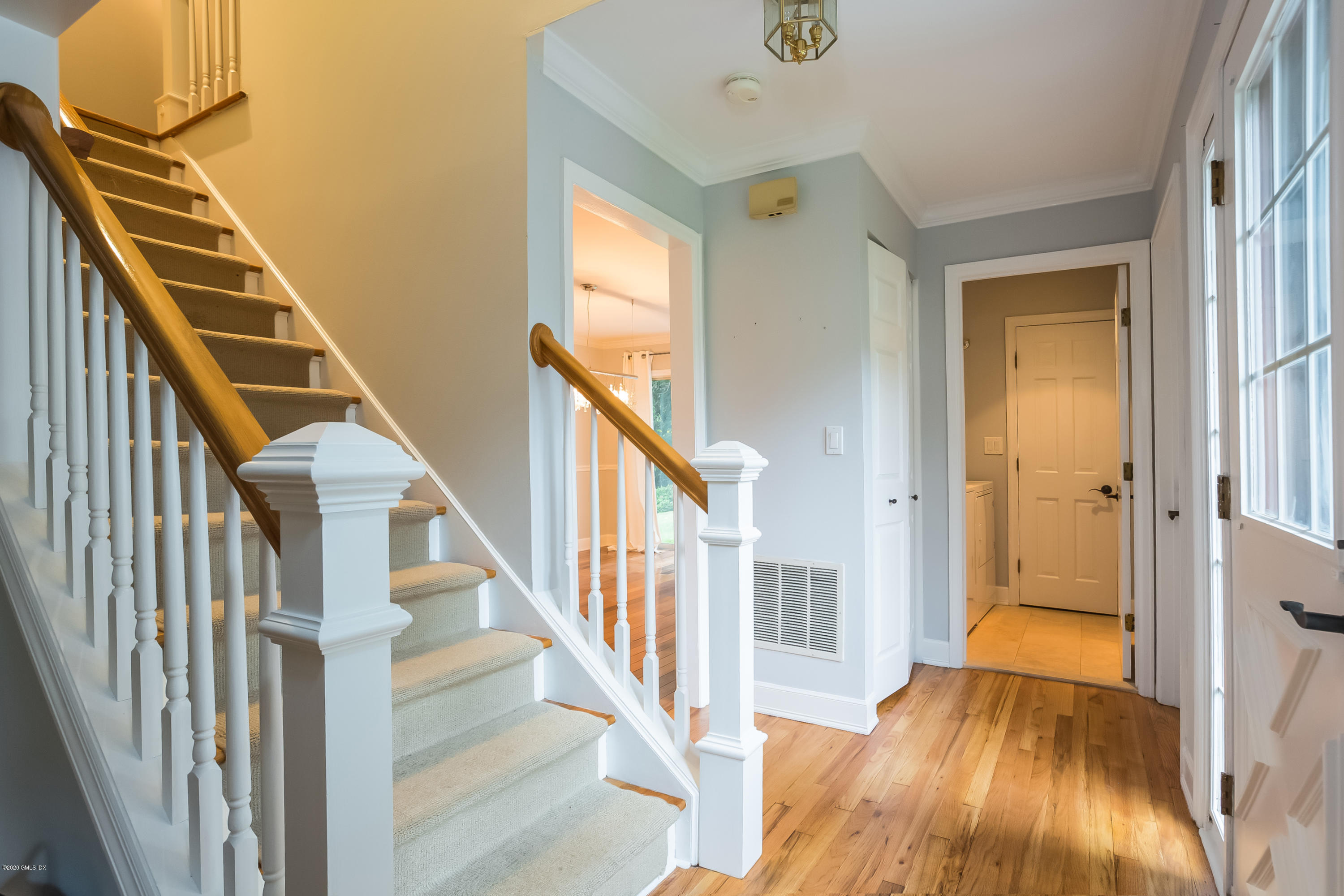 19 Peters Road Riverside, CT 06878 - Photo 3 of 17 a view of a hallway with wooden floor and staircase