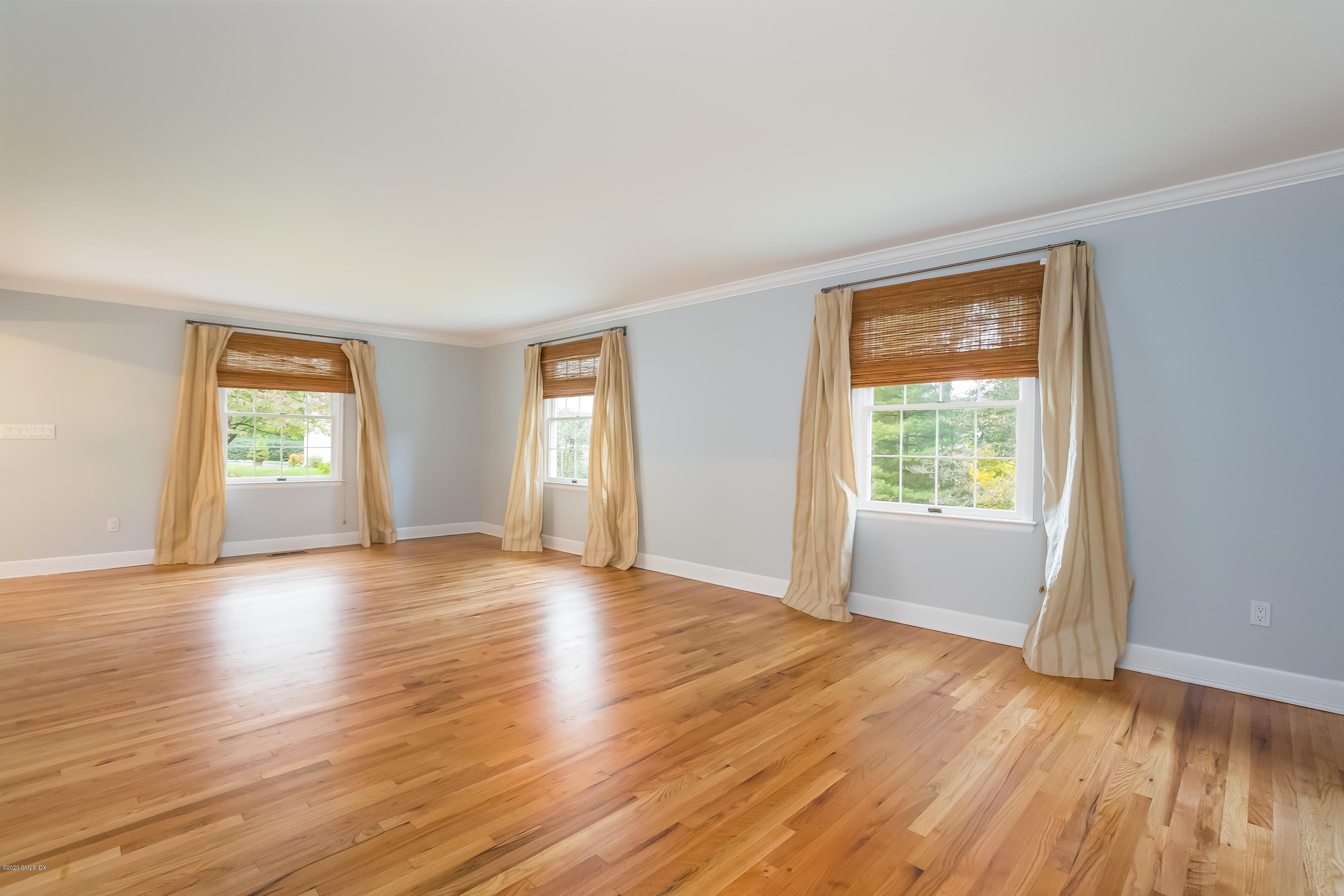 19 Peters Road Riverside, CT 06878 - Photo 4 of 17 an empty room with wooden floor and windows