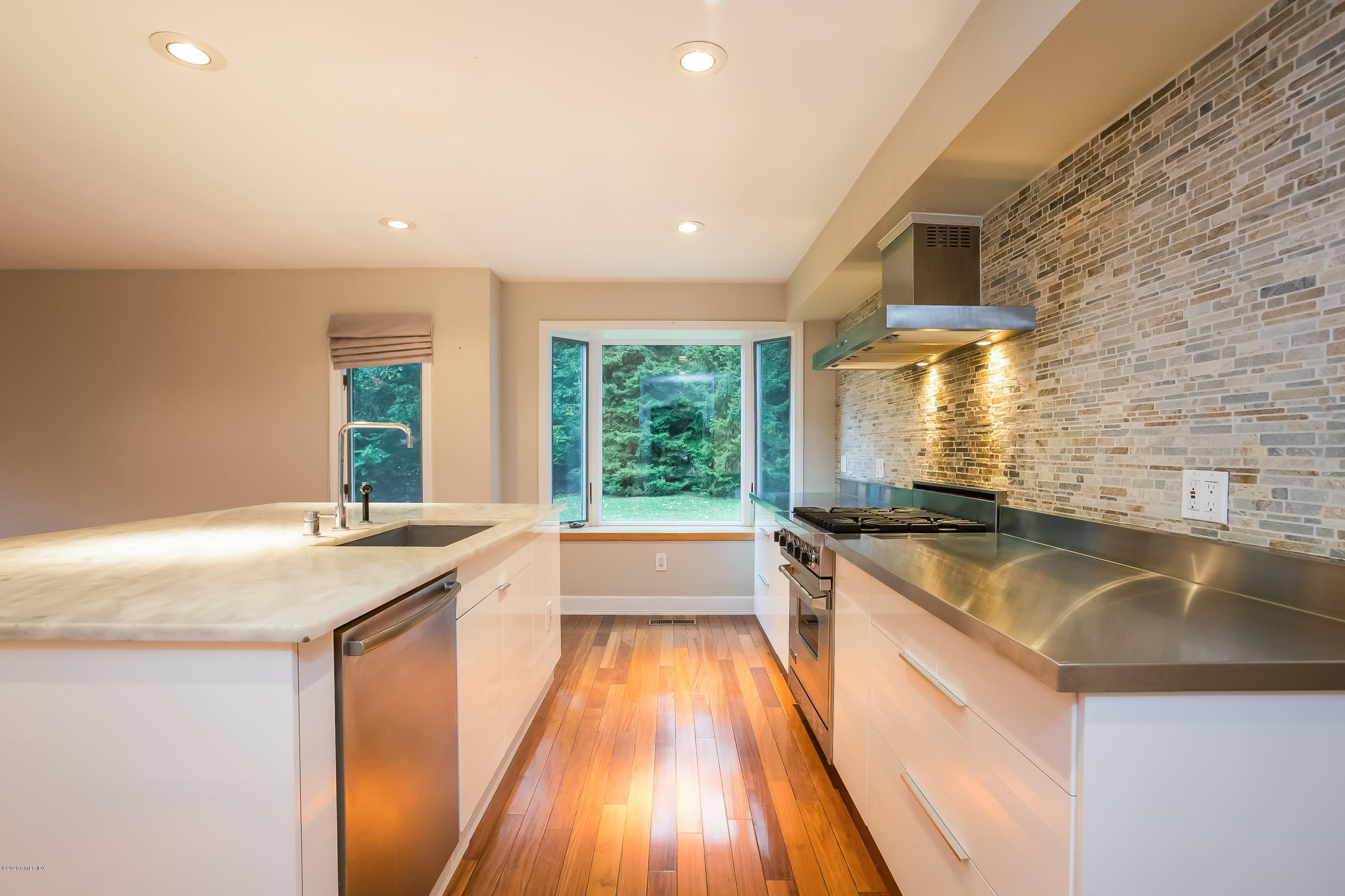 19 Peters Road Riverside, CT 06878 - Photo 6 of 17 a kitchen with stainless steel appliances granite countertop a sink and a stove