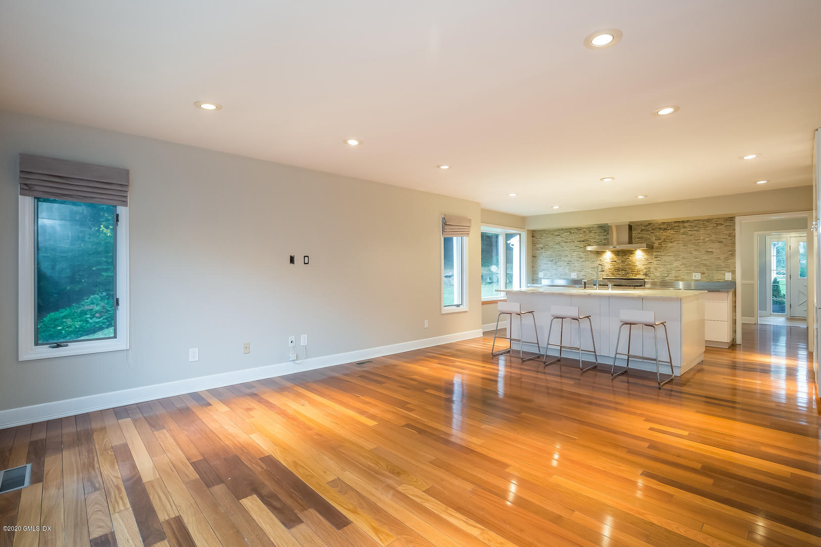 19 Peters Road Riverside, CT 06878 - Photo 8 of 17 a living room with a kitchen island furniture and a kitchen view