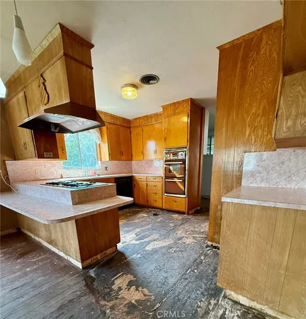 a view of an empty room with window and fireplace