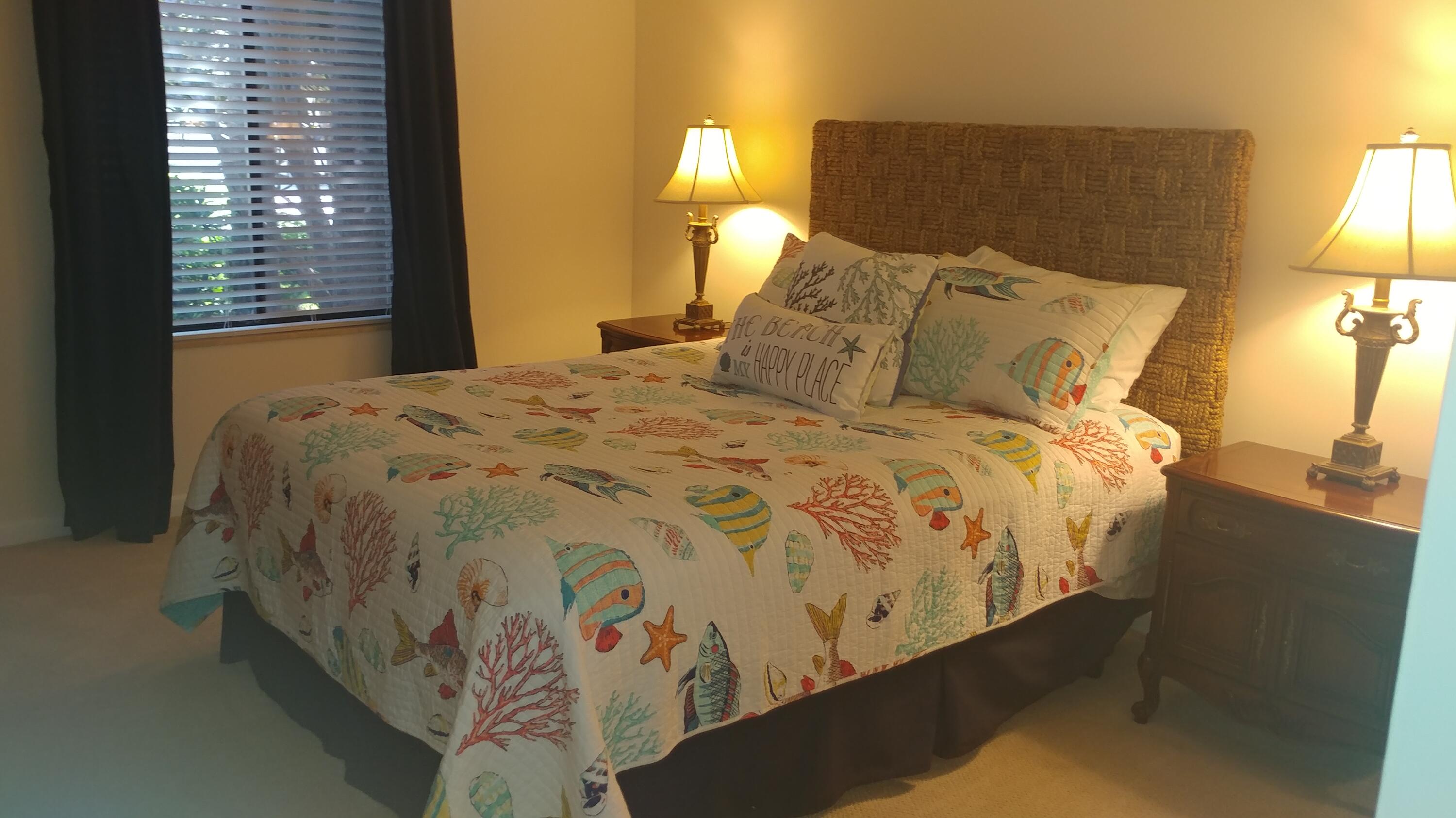 218 Ridge Road Jupiter, FL 33477 - Photo 6 of 7 a bed sitting in a bedroom next to a lamp