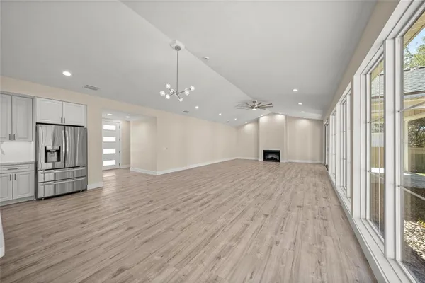 a view of empty room with wooden floor and window