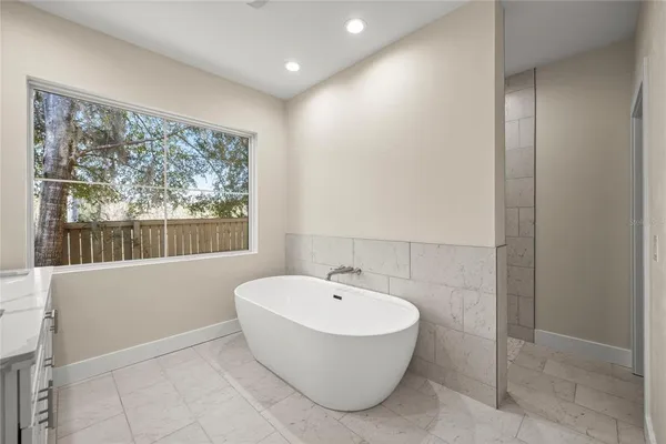 a bathroom with a bathtub and a shower