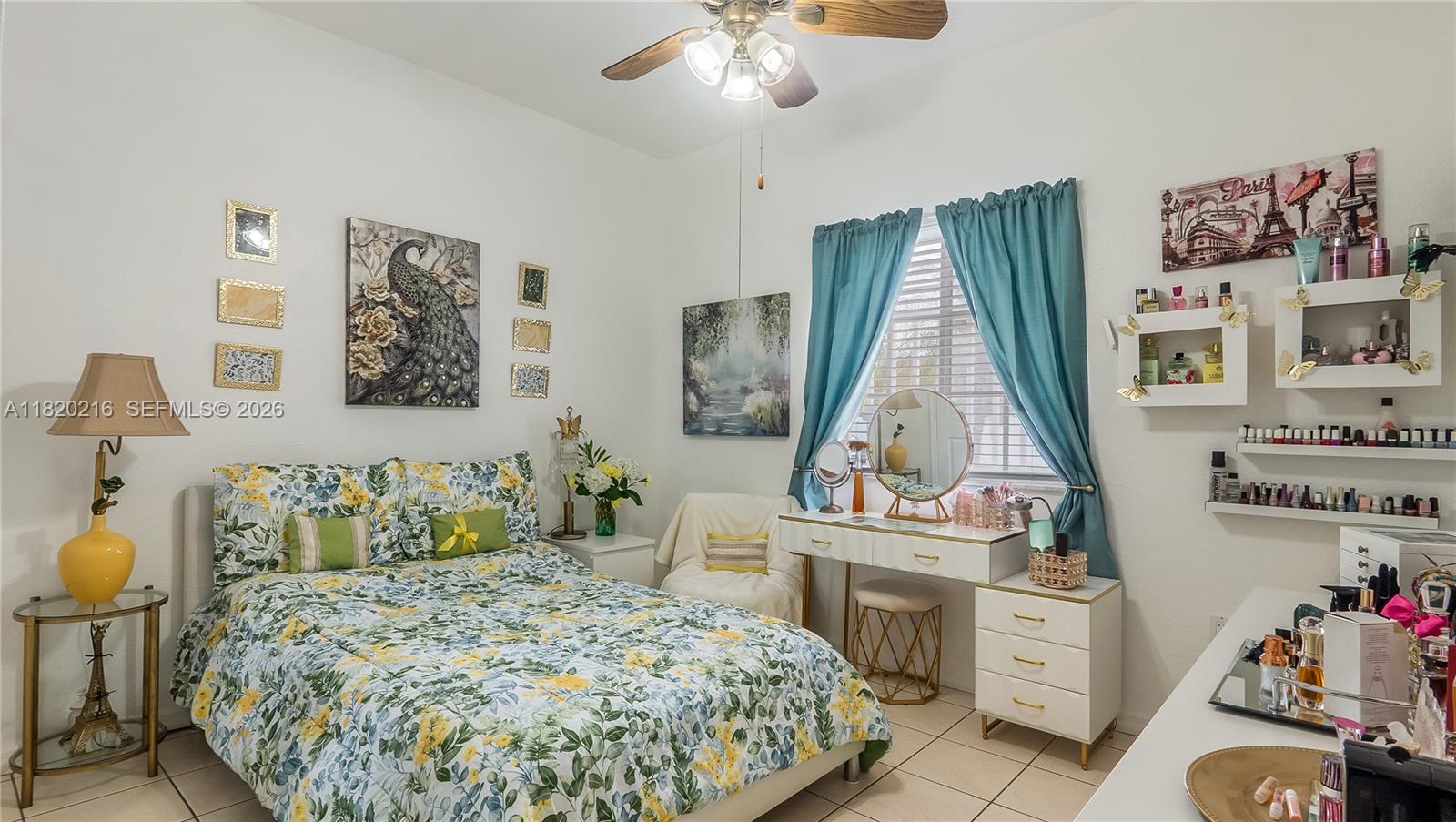 19730 Northwest 78th Avenue Hialeah, FL 33015 - Photo 12 of 30 a bedroom with a bed and a chandelier