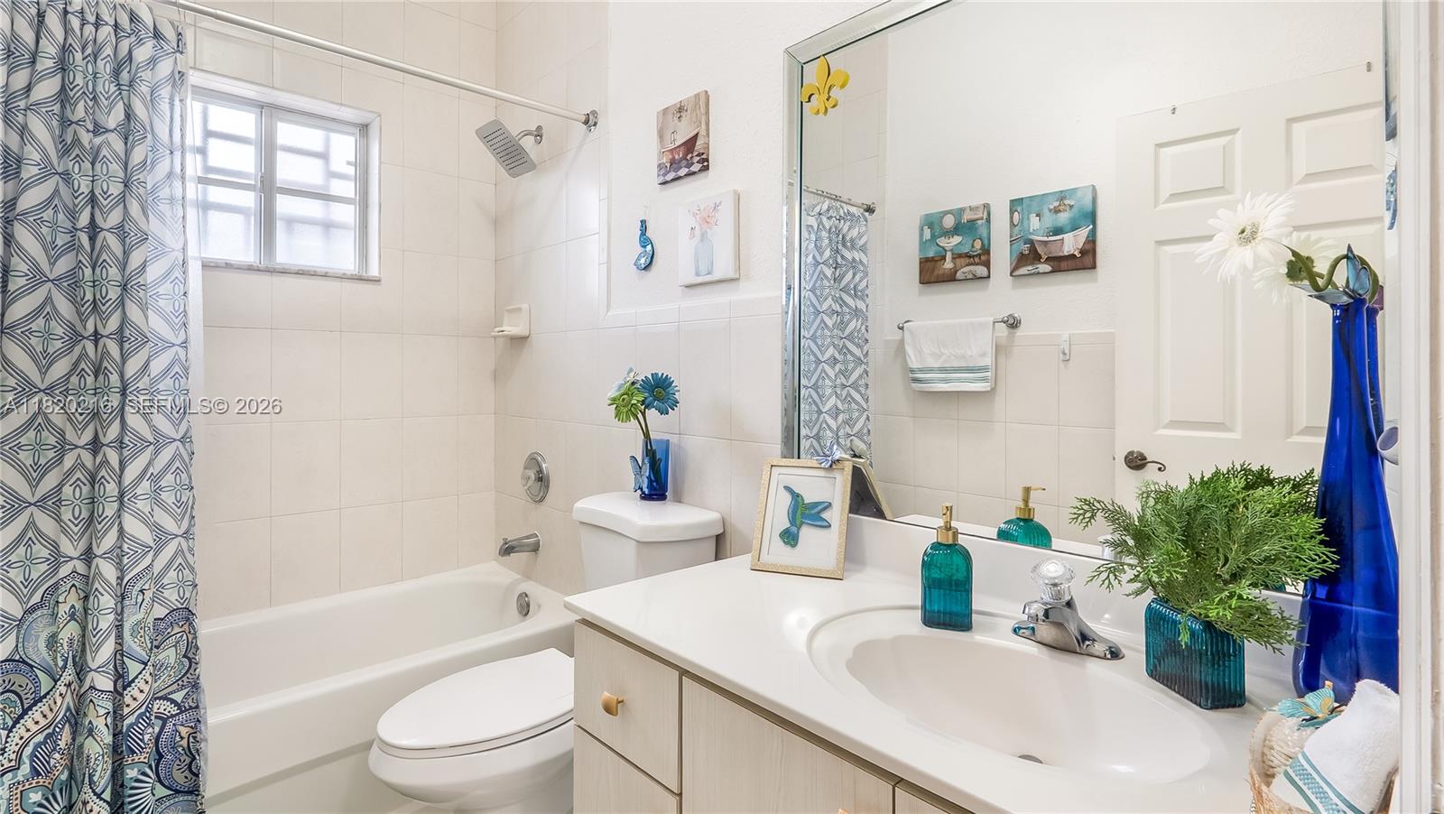 19730 Northwest 78th Avenue Hialeah, FL 33015 - Photo 16 of 30 a bathroom with a granite countertop bathtub sink vanity mirror and toilet