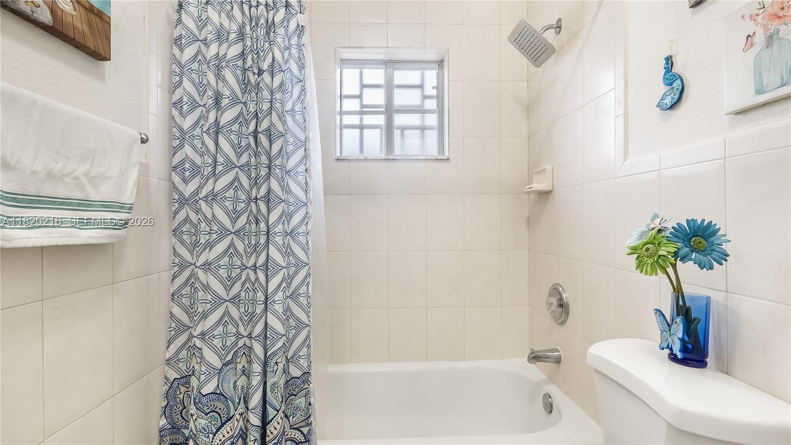 19730 Northwest 78th Avenue Hialeah, FL 33015 - Photo 17 of 30 a bathroom with a shower curtain and a bathtub