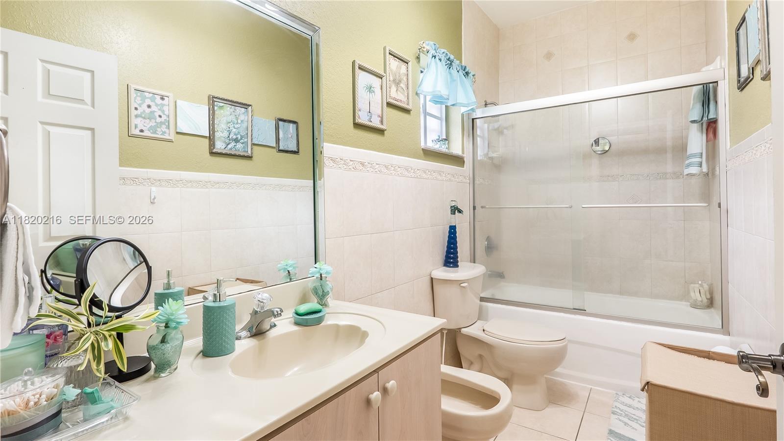 19730 Northwest 78th Avenue Hialeah, FL 33015 - Photo 20 of 30 a bathroom with a granite countertop sink and a mirror