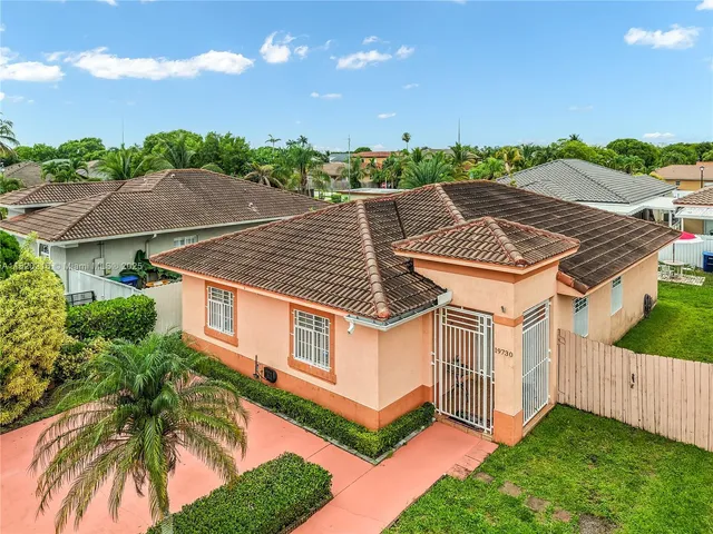 a aerial view of a house with a yard