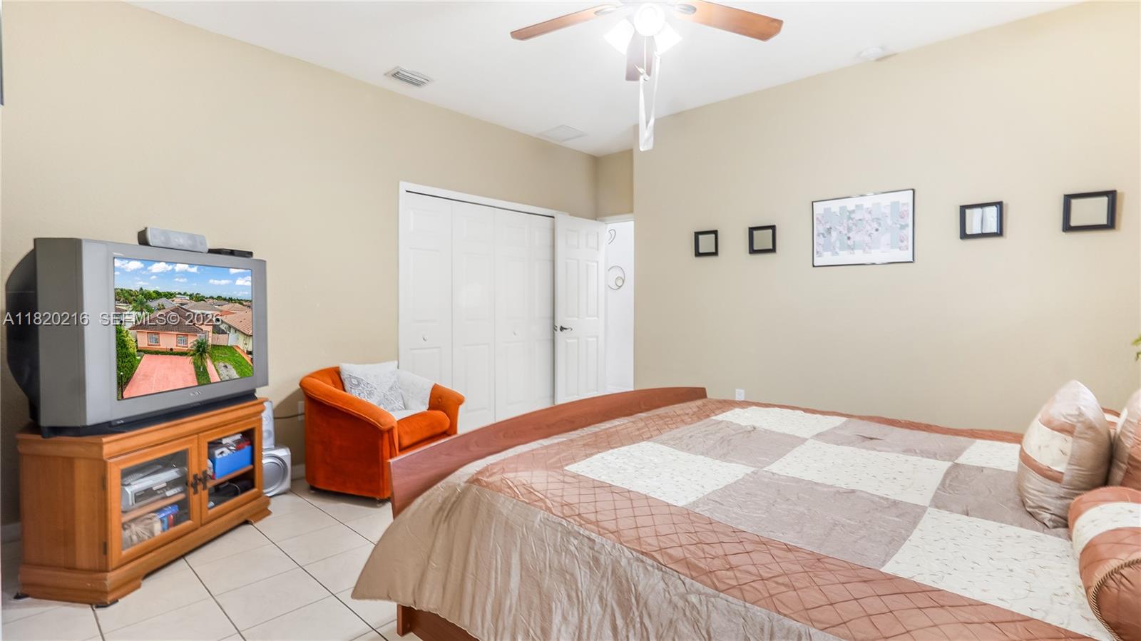 19730 Northwest 78th Avenue Hialeah, FL 33015 - Photo 22 of 30 a bed room with a bed and a tv