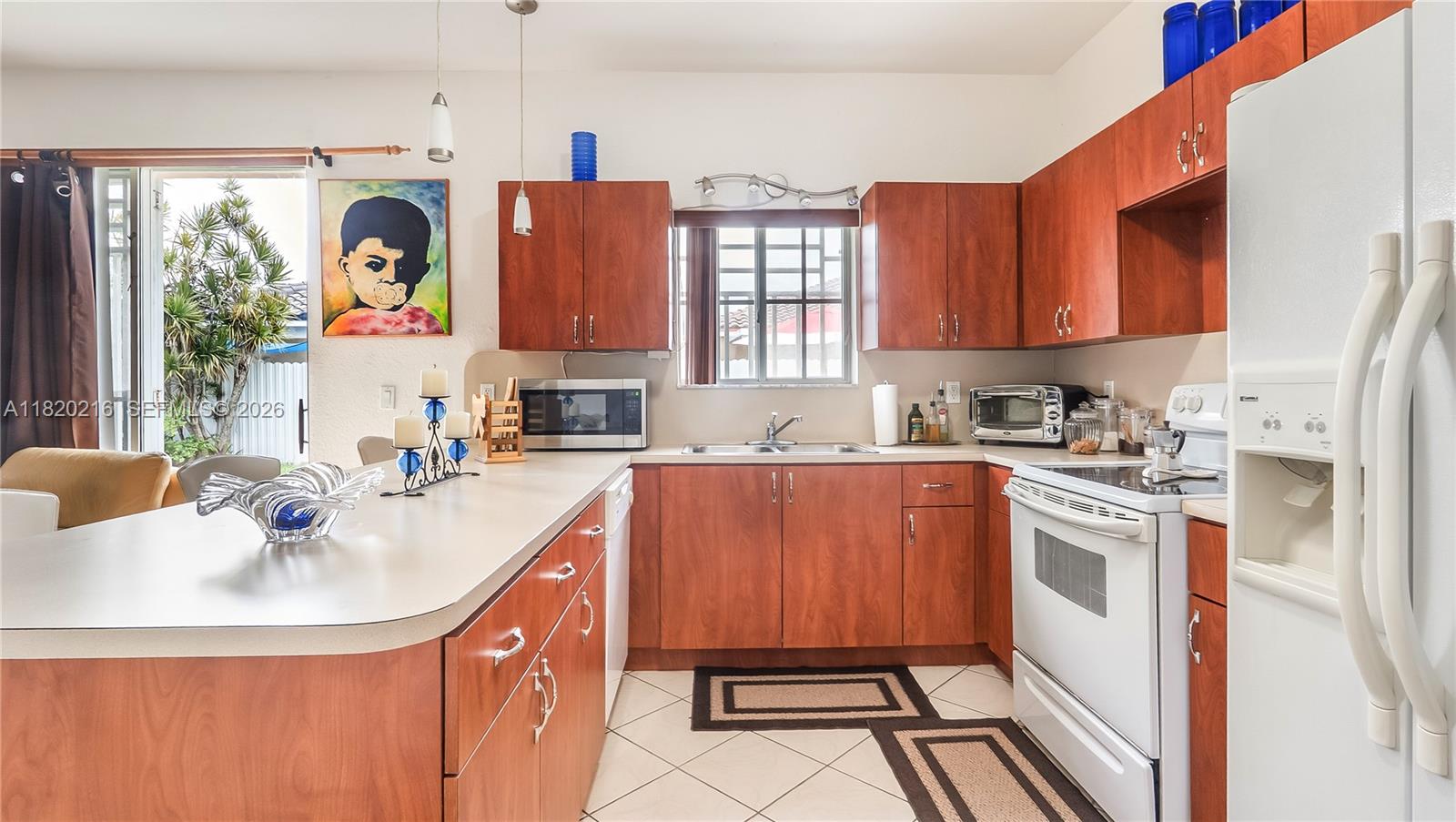 19730 Northwest 78th Avenue Hialeah, FL 33015 - Photo 10 of 30 a kitchen with stainless steel appliances granite countertop a sink a stove and a refrigerator