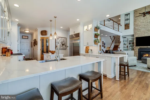 a kitchen with stainless steel appliances granite countertop a sink a stove and a refrigerator