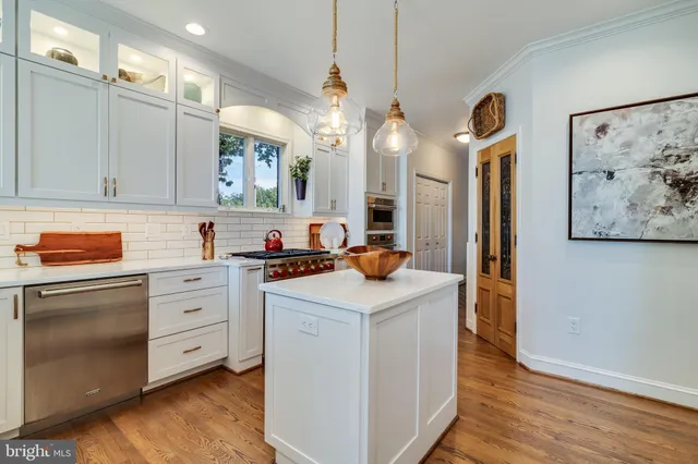 a kitchen with stainless steel appliances granite countertop a sink a refrigerator and a stove