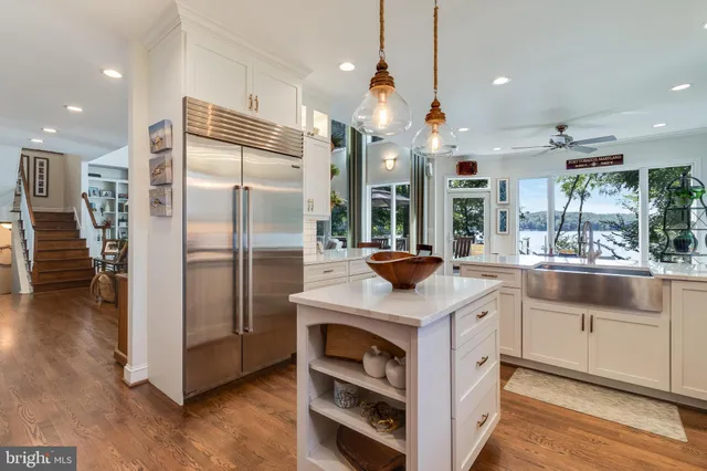 a dining room with furniture a chandelier and wooden floor