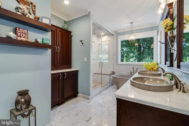 a living room with stainless steel appliances furniture and kitchen view