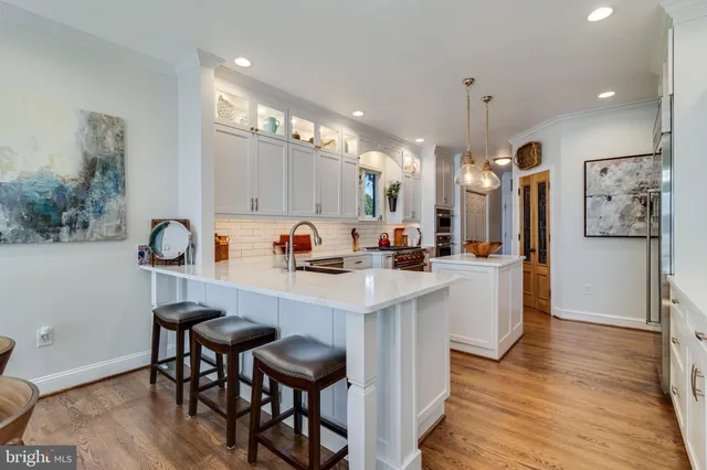 a view of a hallway with paintings on the wall