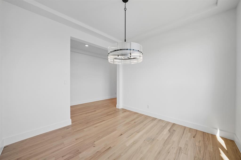 587 Mayfair Lane Frisco, TX 75033 - Photo 8 of 37 a view of a room with wooden floor and a chandelier