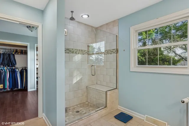 a bathroom with a glass shower door