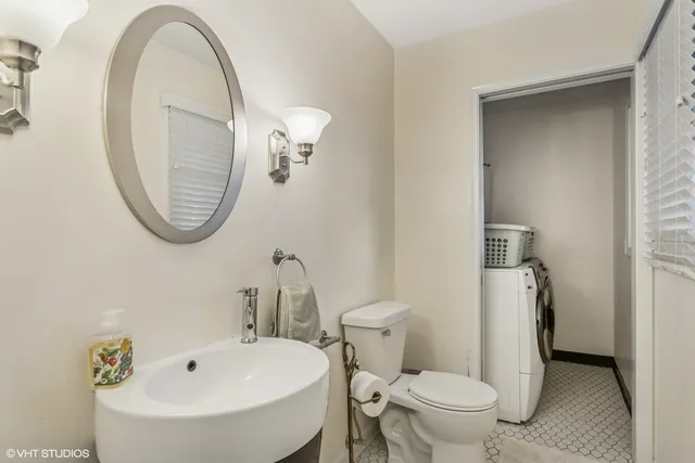 a bathroom with a sink a toilet and a mirror