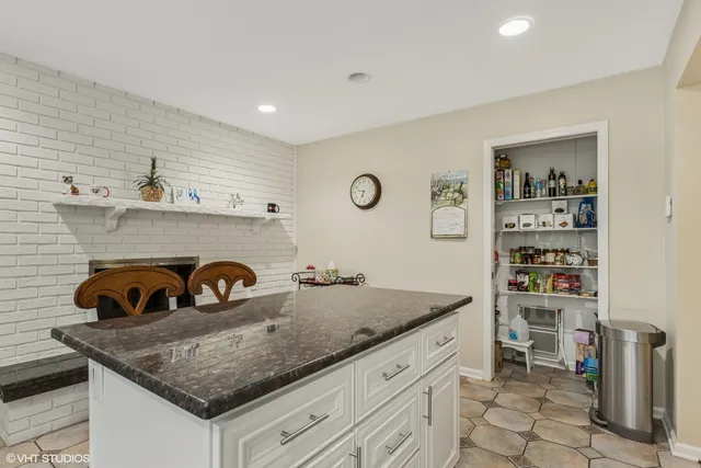 a kitchen with a sink a stove and cabinets