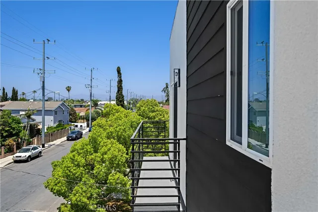 a view of an empty room with wooden floor and closet