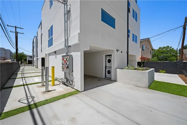 a view of kitchen with stainless steel appliances wooden floor and window