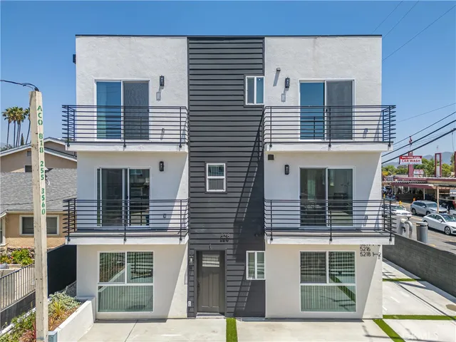 a front view of a house with large windows