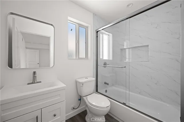 a kitchen with granite countertop a refrigerator and a sink