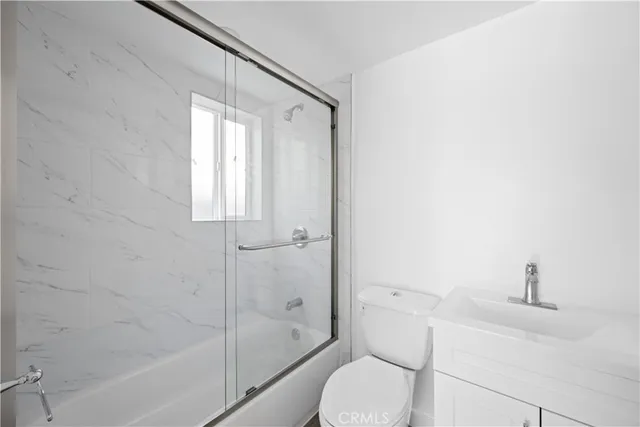 a kitchen with stainless steel appliances a refrigerator and a stove top oven