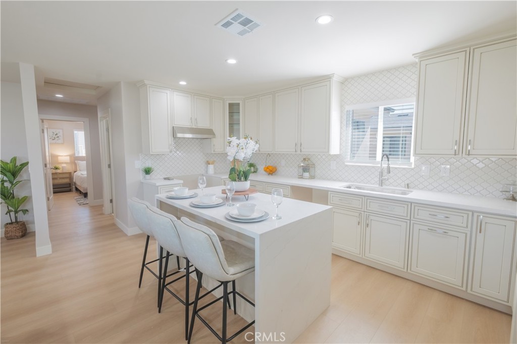 223 South Aprilia Avenue Compton, CA 90220 - Photo 6 of 46 a kitchen with center island table and chairs in it