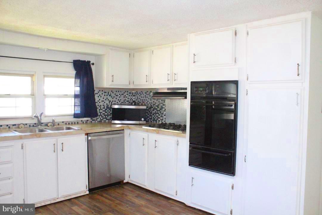 1762 Crown Point Road, Unit 2310B West Deptford, NJ 08086 - Photo 3 of 39 a kitchen with granite countertop a refrigerator and a stove