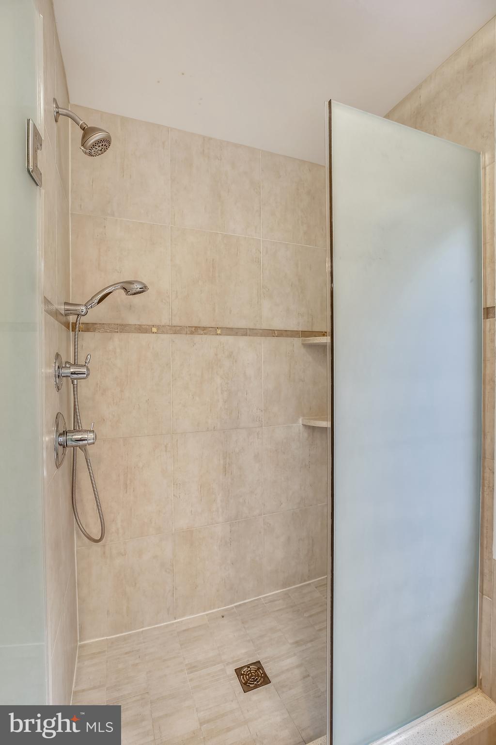 7903 Springer Road Bethesda, MD 20817 - Photo 45 of 83 Each shower is fully tiled, shadowed glass