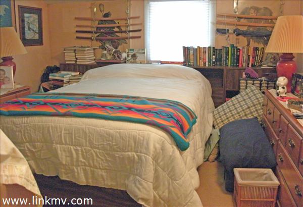 29 Chase Road Edgartown, MA 02539 - Photo 3 of 6 a bedroom with a bed and a table