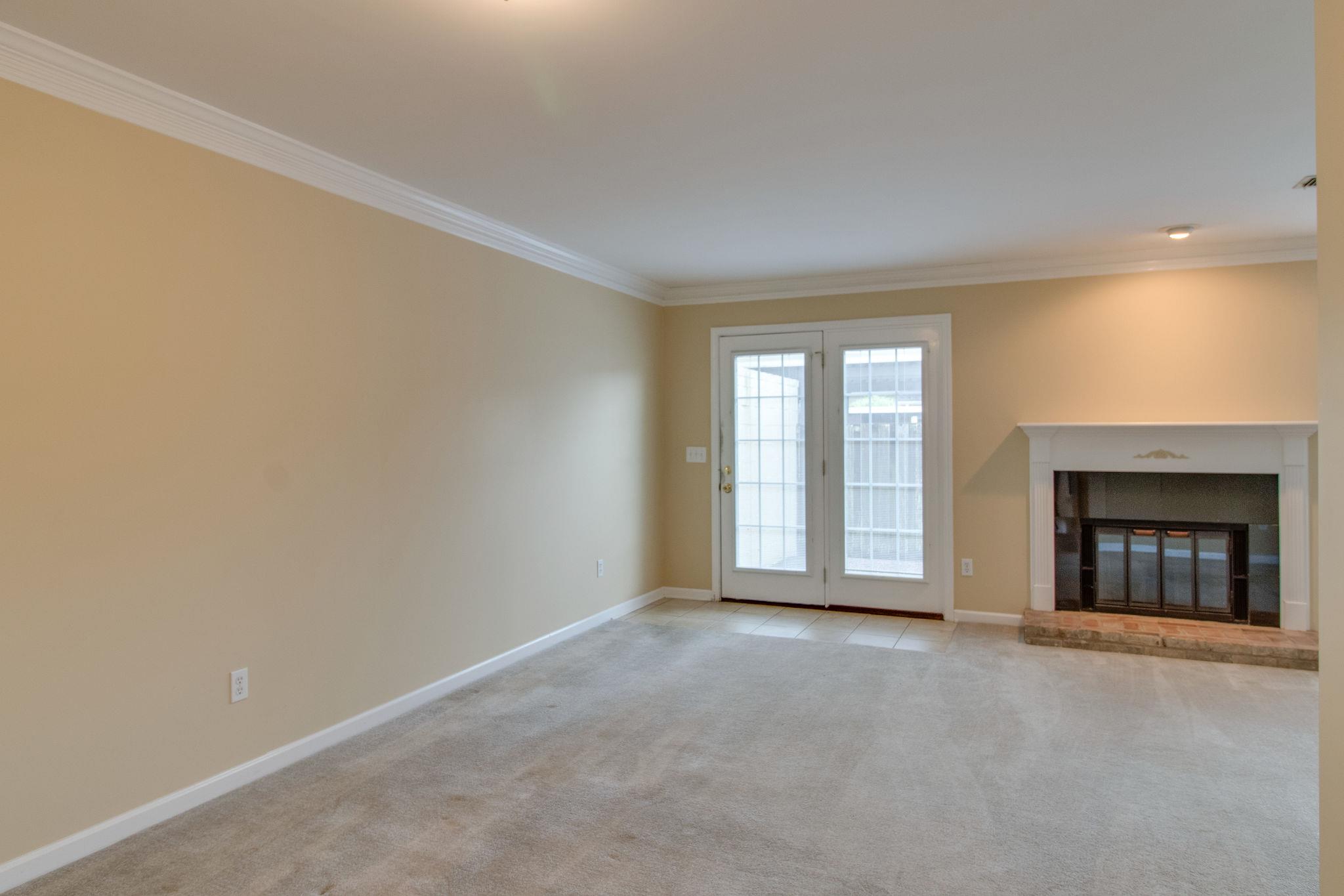 1253 General George Patton Road, Unit 1253 Nashville, TN 37221 - Photo 8 of 25 a view of an empty room with a fireplace and a window