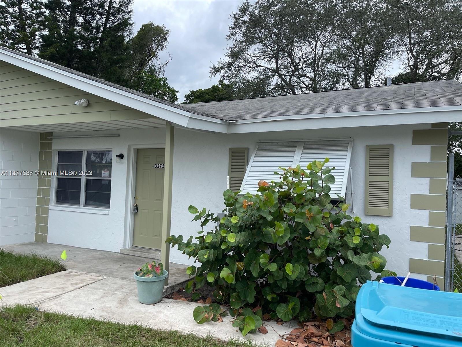 3275 Grove Road Boynton Beach, FL 33435 - Photo 2 of 3 a front view of a house with plants