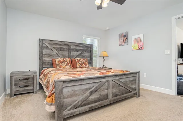 a bed sitting in a bedroom next to a window