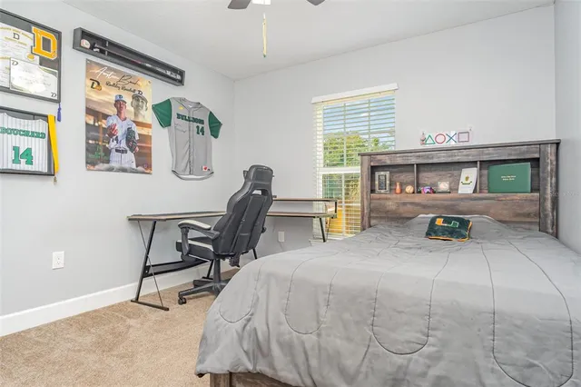a bedroom with a bed a table and chair with the outer view