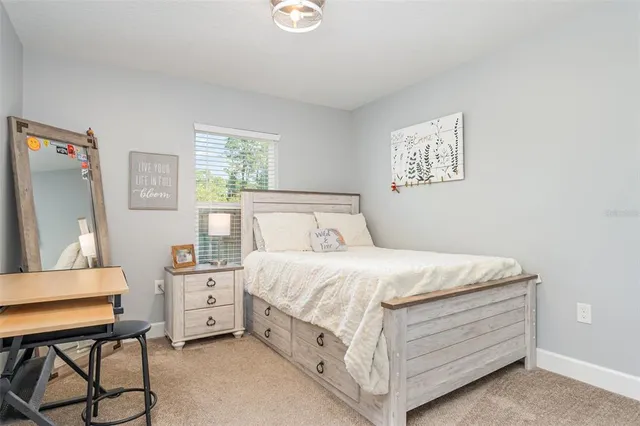 a bedroom with a bed and a desk